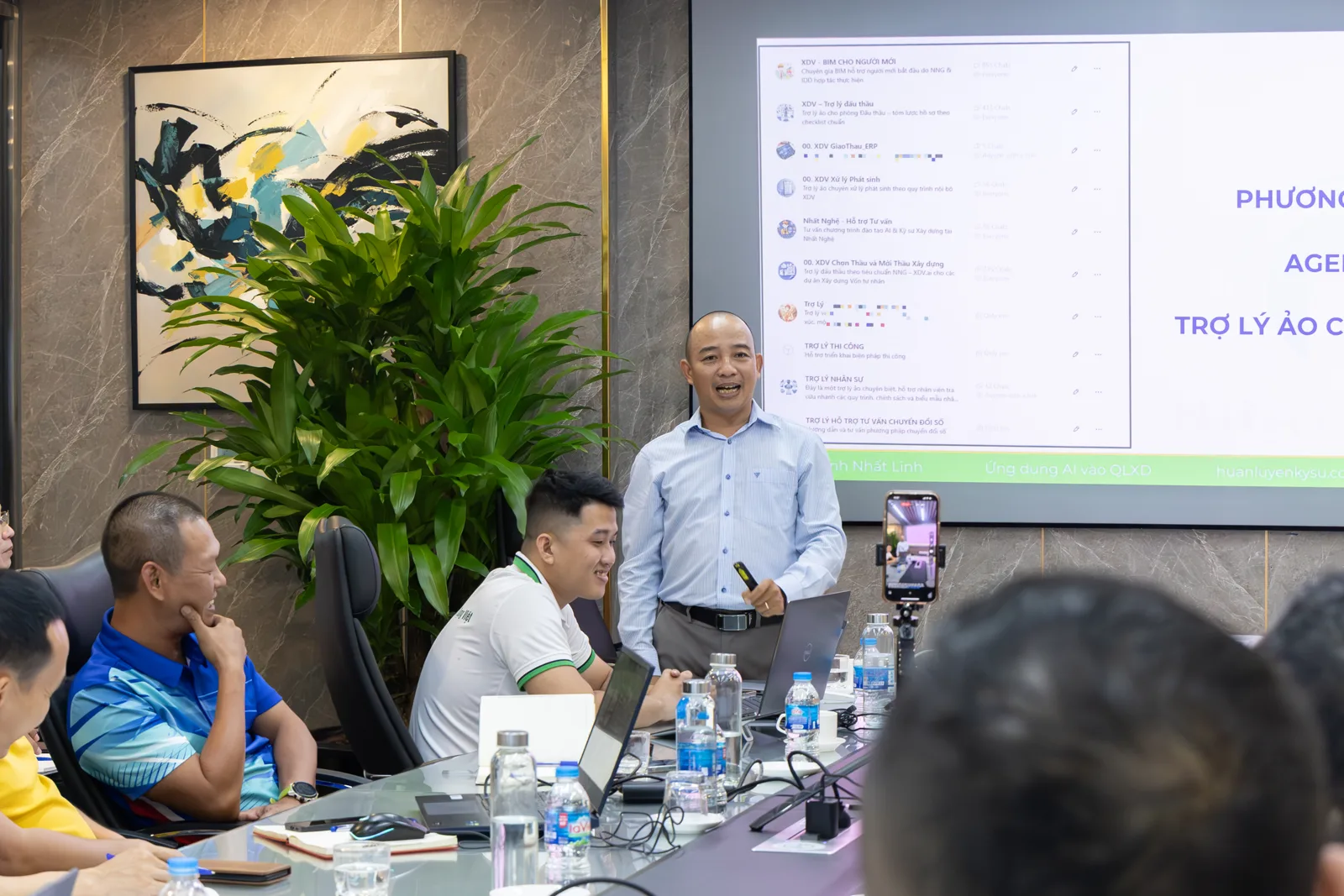 Thầy Huỳnh Nhất Linh cầm micro giảng bài, nhìn về phía học viên tại lớp học TP.HCM